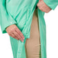 Close-up of person adjusting side vent on mint green Equine Couture Ladies Downpour Rain Jacket for equestrian use