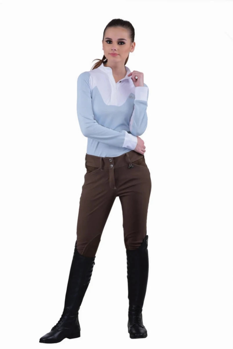Woman wearing Equine Couture Ladies Sportif Natasha Knee Patch Breeches - UltraGripp Suede Riding Pants with Wide Waistband standing confidently