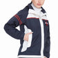 Woman modeling Women's Rain Jacket - Waterproof Shell with Adjustable Hood in navy with white and red accents, hand in pocket.