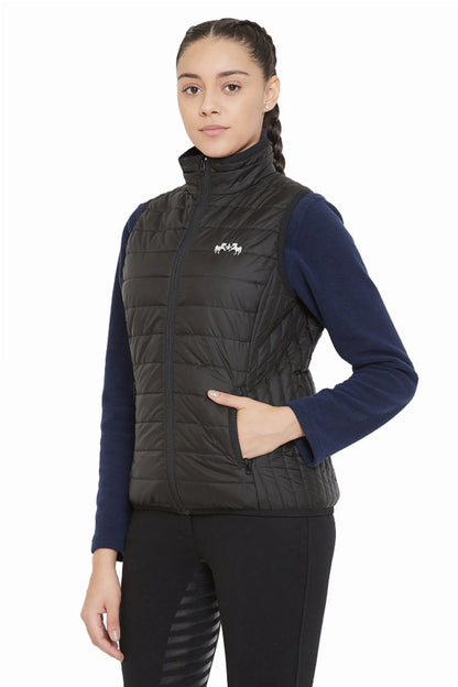Woman wearing a black Equine Couture Ladies Zima Vest with quilted design and embroidered logo on front