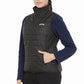 Woman wearing black Equine Couture Ladies Zima Vest with navy long sleeve top, hand in pocket, standing against white background
