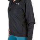 Woman wearing a black Equine Couture Ladies Aberdeen Jacket with horse logo and blue riding pants in white background.