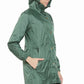 Woman wearing a green Equine Couture Element Rain Jacket with hood, side pockets, and snap button closure in profile view