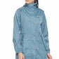 Woman wearing blue Equine Couture Element Rain Jacket with hood and button details, posing for outdoor wear display