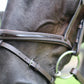 Patent Leather Horse Bridle - Padded Monocrownpiece Bridle with Flash Noseband and Rubber Reins on horse head close-up