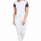 Woman wearing Women's Riding Breeches - Coolmax Microfiber with Silicone Knee Patches standing barefoot in white breeches and a white polo shirt.