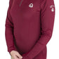 Woman wearing a burgundy Lettia Women Quarter-Zip Neck UPF 50+ Sun Shirt adjusting sleeve with a smile