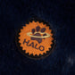 Close-up of a round dog bed fabric patch featuring the logo on the Round Dog Bed - Preppy Color Block Bed with Removable Washable Cover