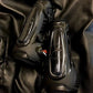 Pair of shiny black protective horse boots resting on black leather fabric, featuring eQuick eShock Legend Front Boot- Black- Medium.