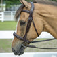 Horse wearing a brown Henri de Rivel Pro Mono-Crown Padded Wide Noseband Bridle in an outdoor riding arena