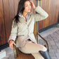 Woman wearing 5/A Baker Ladies Country Quilted Jacket - Lightweight Riding Jacket with Baker Plaid Lining sitting outdoors on a wicker chair