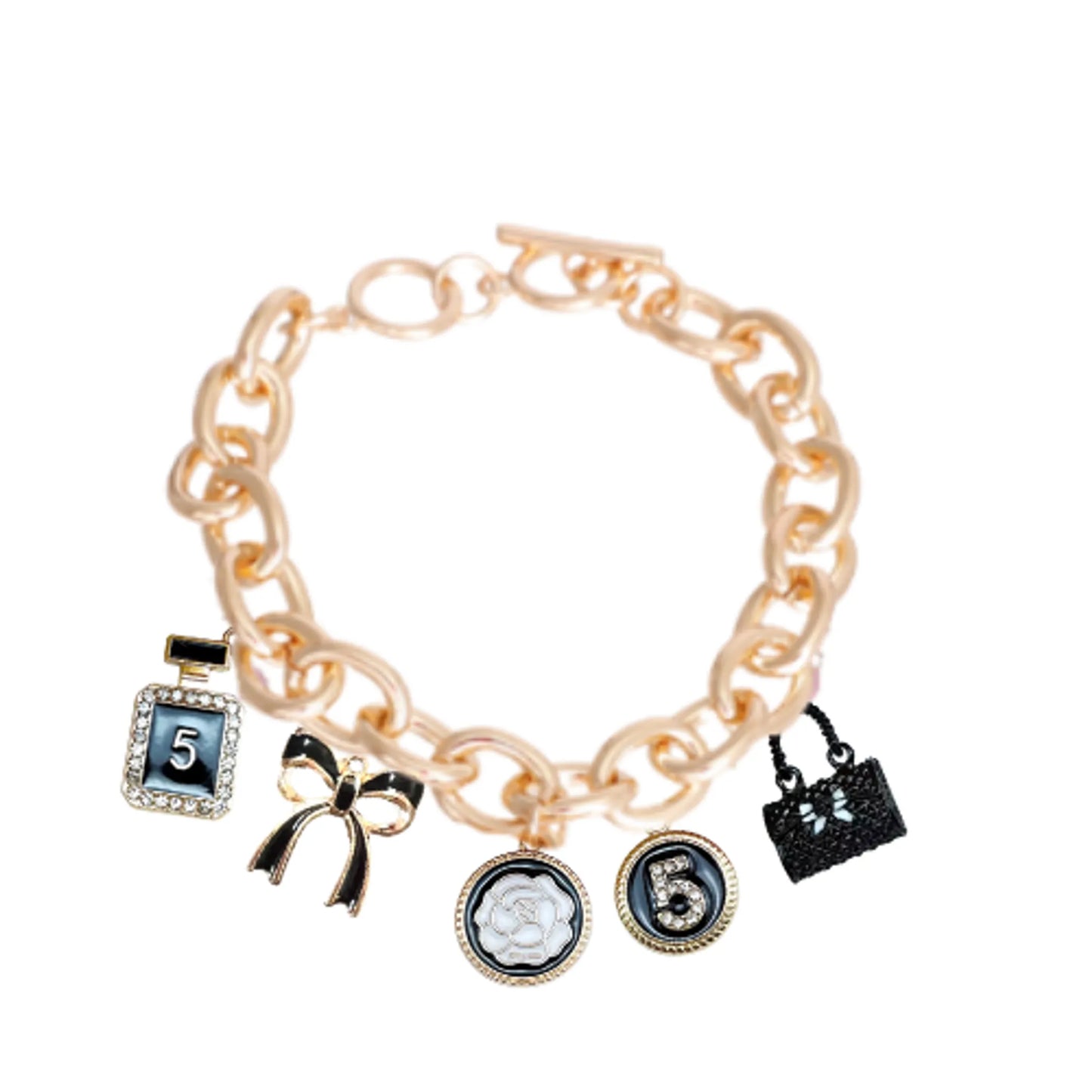 Bags & Bows Charm Necklace with gold chain and five stylish black, white, and gold charms including bow and handbag designs