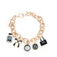 Bags & Bows Charm Necklace with gold chain featuring perfume bottle, bow, flower, number 5, and handbag charms