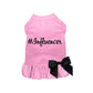 Pink pet dress with ruffled hem and black bow, featuring "#Influencer Dress" text for stylish pet supplies look.