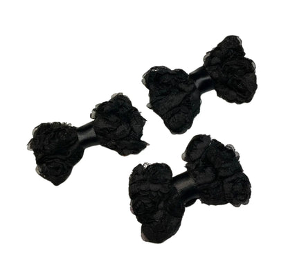Three black chiffon rosette hairbows with textured floral design against white background
