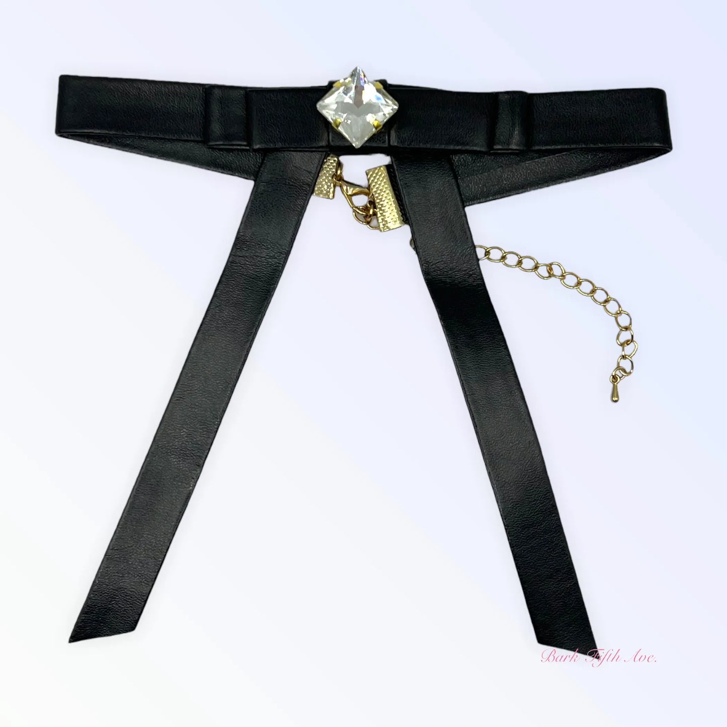 Black Vegan Leather Long Bow Necklace with gold chain and clear square gemstone centerpiece on white background