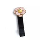 Camellia Hair Clips featuring a pink flower design with a yellow center on a black fabric clip.