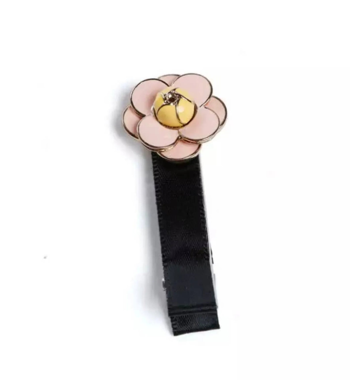 Camellia Hair Clips featuring a pink flower design with a yellow center on a black fabric clip.