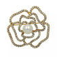Camellia Luxury Brooch featuring gold-tone petals outlined with crystals and a large central pearl accent
