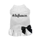 White pet dress with #Influencer printed in black and a black bow on a ruffled skirt, called #Influencer Dress