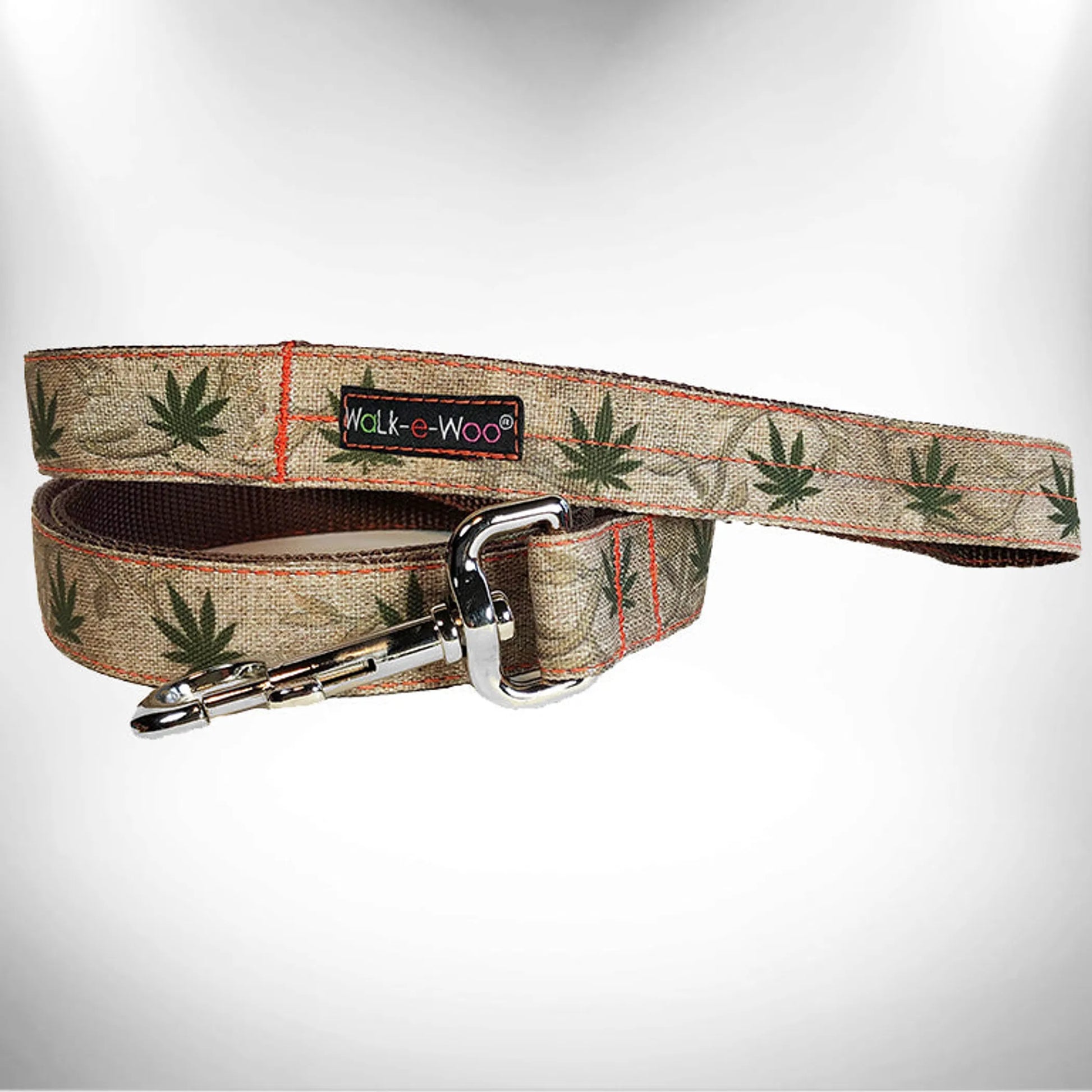 RaDog Leash with beige fabric featuring green leaf patterns and a sturdy silver metal clasp for pets.