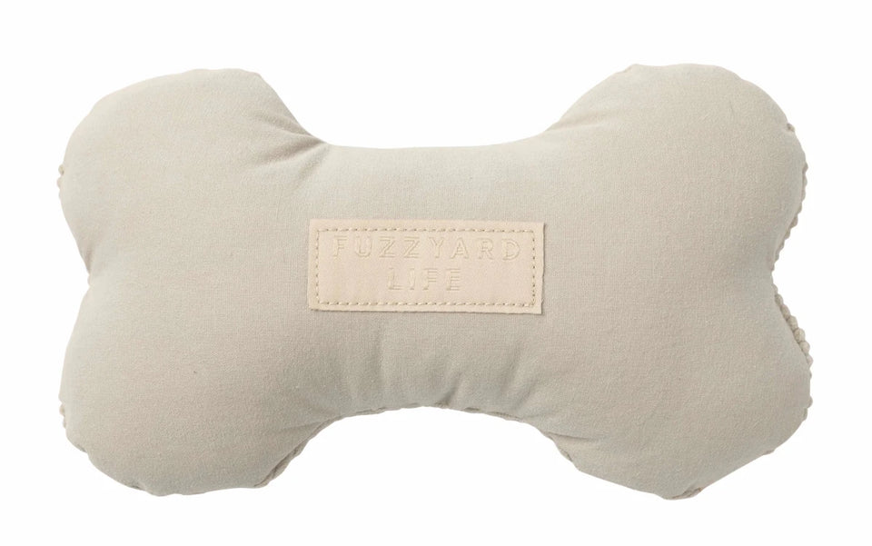Cream FuzzYard Life bone-shaped plush dog toy, front view