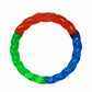 KONG(R) Twistz Ring Dog Tug Toy in red, green, and blue, durable braided rubber for interactive dog play