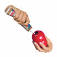 Hands filling a red dog toy with KONG(R) Stuff'N Real Peanut Butter 5 oz in a controlled pet supply setting