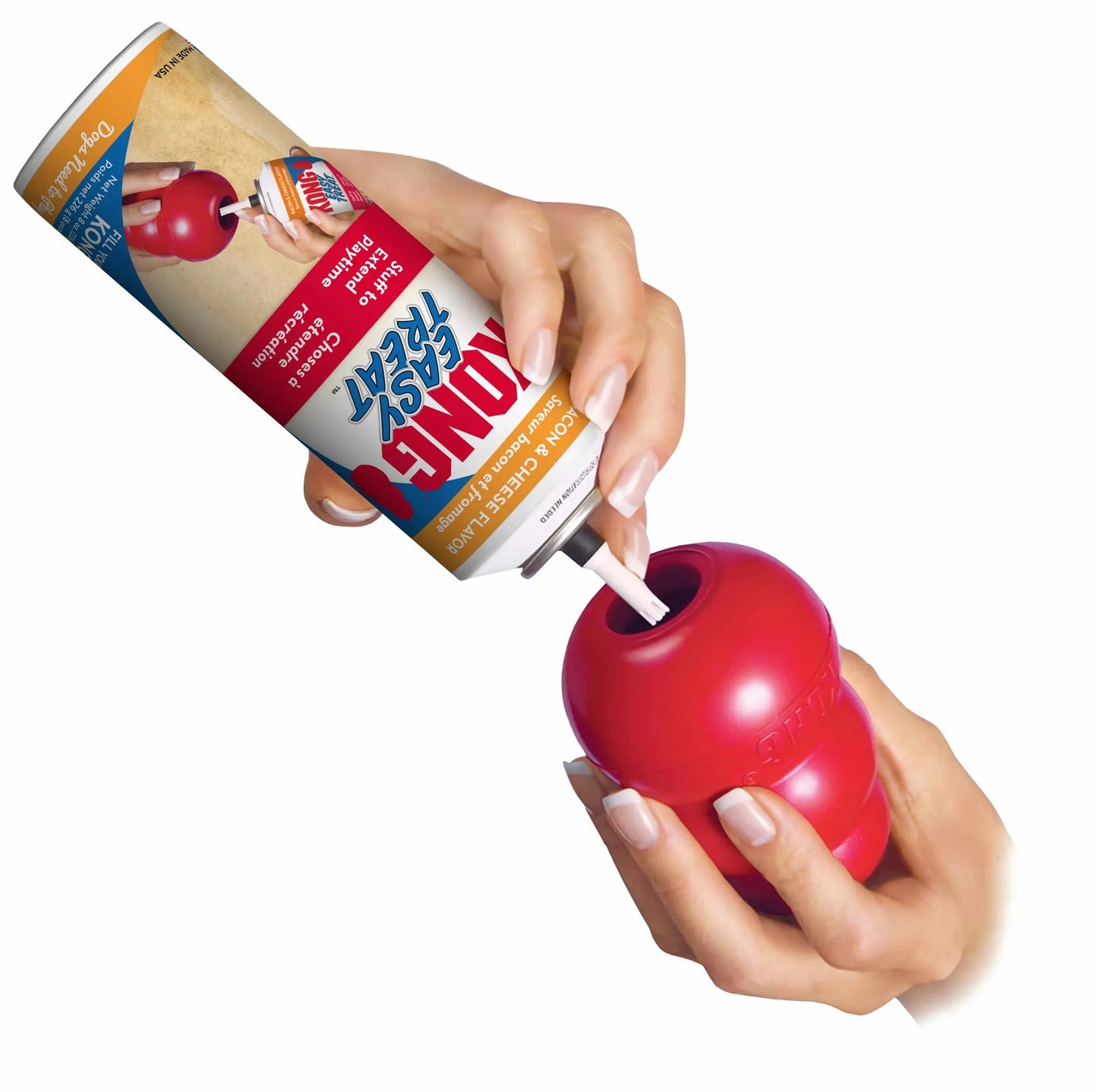 KONG(R) Easy Treat(R) Bacon & Cheese 8 oz being squeezed into a red KONG dog toy by two hands.