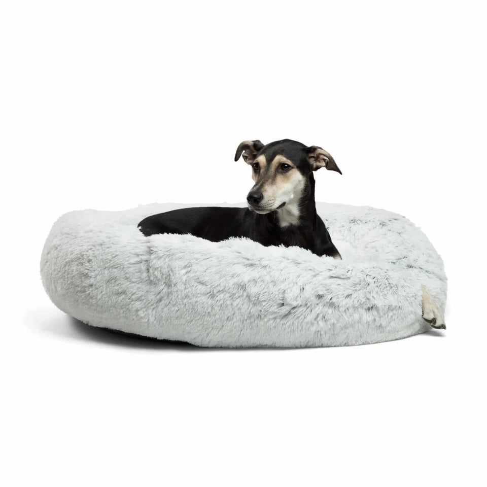 Small black dog resting in a gray Best Friends by Sheri shag donut bed
