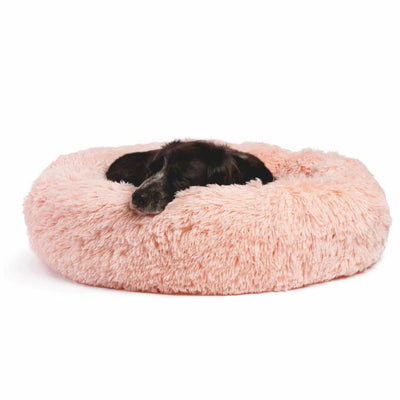 Black puppy sleeping in a pink Best Friends by Sheri shag donut bed