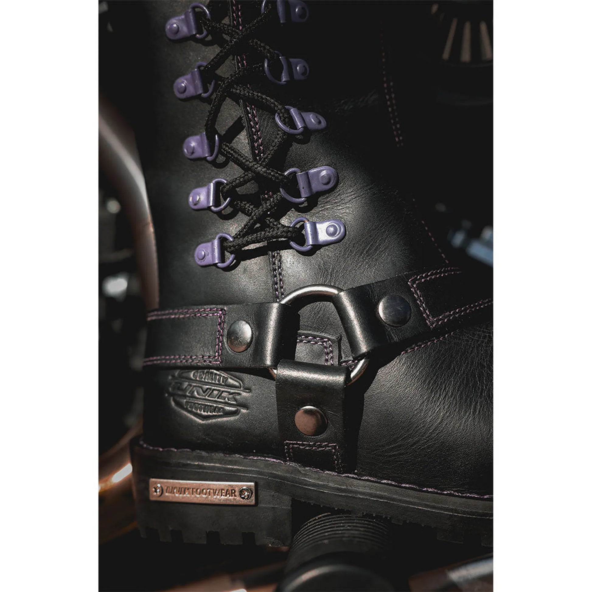 Close-up of black leather 12000.17 -Ladies Motorcycle Biker Leather Boots with purple lace hooks and sturdy sole.