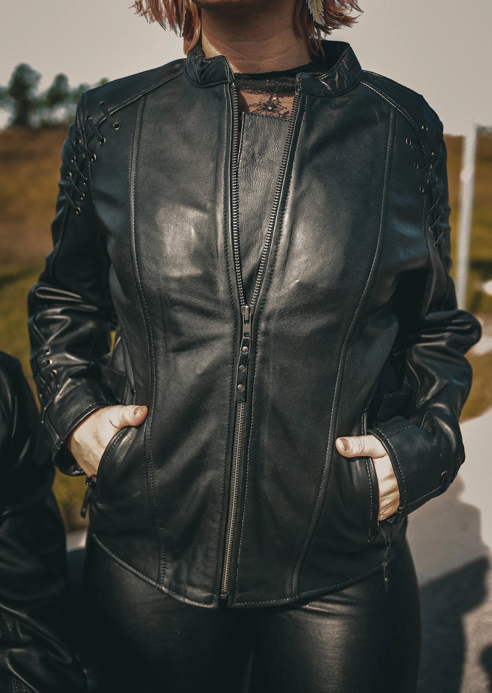 Woman wearing a black zip-up 6829.00 - Ladies Premium Leather Jacket with pockets in an outdoor setting