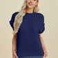 Woman wearing a navy blue Double Take Full Size Mock Neck Short Sleeve Sweater with casual blue jeans