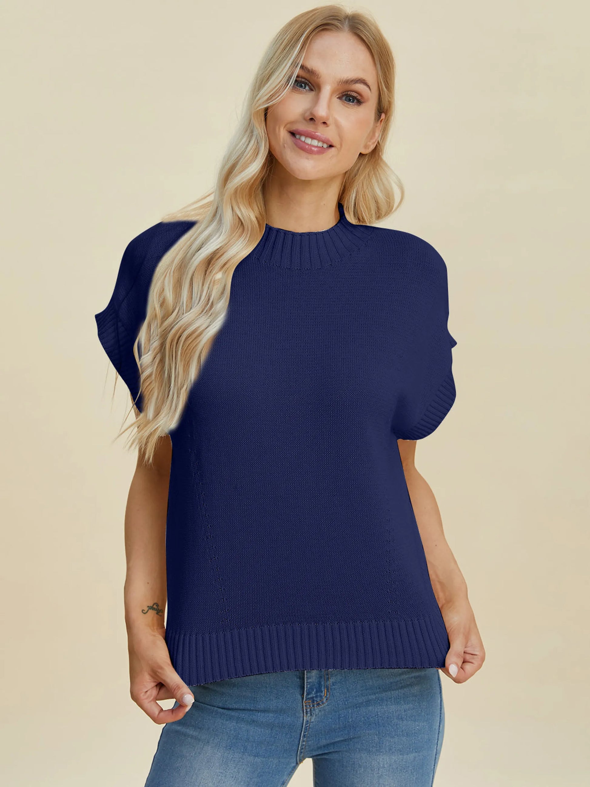 Woman wearing a navy blue Double Take Full Size Mock Neck Short Sleeve Sweater with casual blue jeans