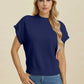 Woman wearing navy blue Double Take Full Size Mock Neck Short Sleeve Sweater with casual jeans on neutral background