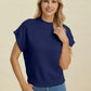 Woman wearing a navy blue Double Take Full Size Mock Neck Short Sleeve Sweater with casual jeans against a neutral background