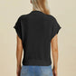 Back view of woman wearing black Double Take Full Size Mock Neck Short Sleeve Sweater with light blue jeans