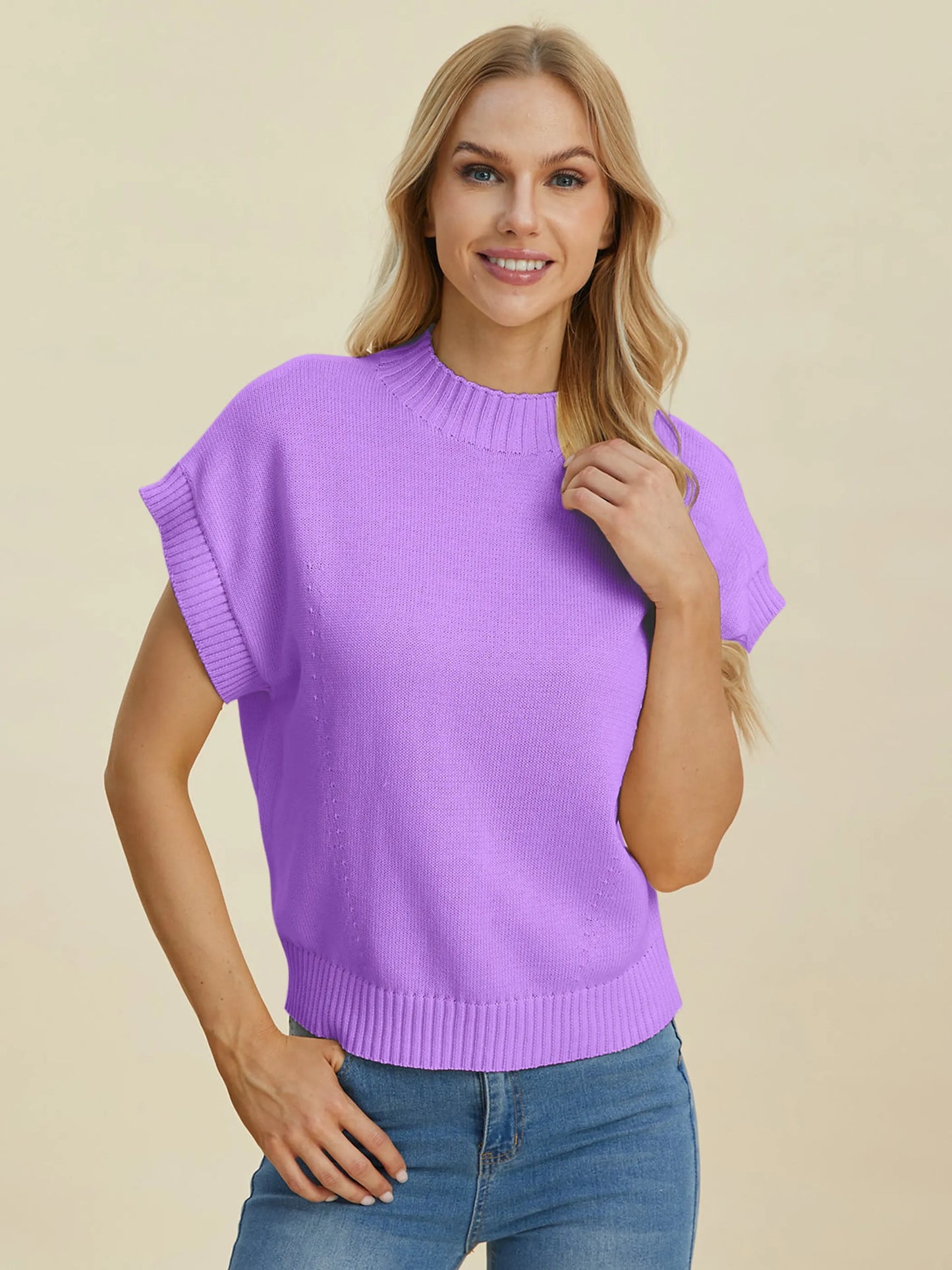 Woman wearing a lavender Double Take Full Size Mock Neck Short Sleeve Sweater with ribbed edges and casual fit.