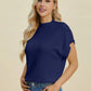 Woman wearing navy Double Take Full Size Mock Neck Short Sleeve Sweater with ribbed collar and sleeves paired with jeans