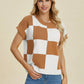 Woman wearing Double Take Full Size Checkered Round Neck Short Sleeve Sweater in brown and white checkered pattern.