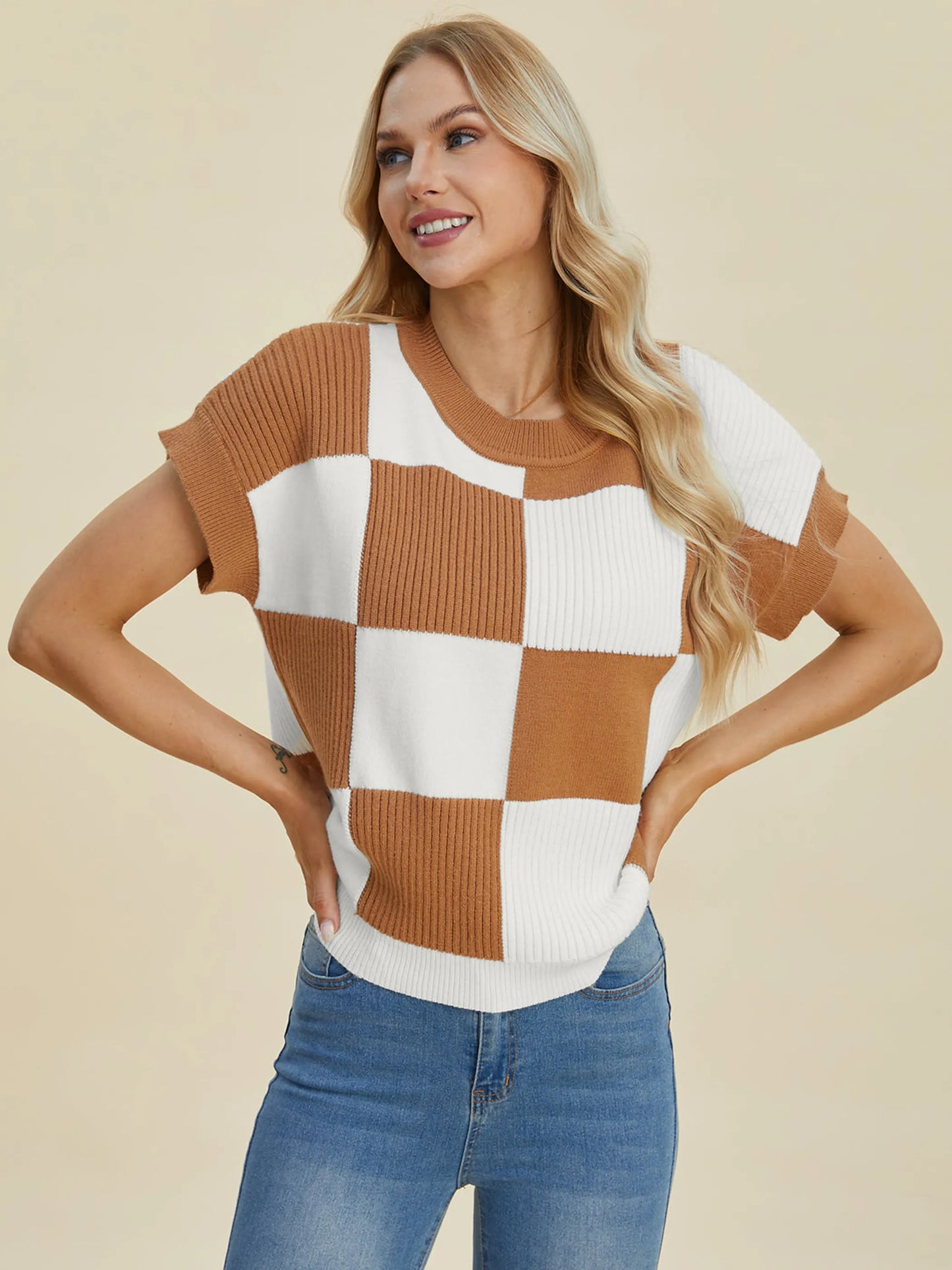 Woman wearing a tan and white checkered knit top posing, Double Take Full Size Checkered Round Neck Short Sleeve Sweater