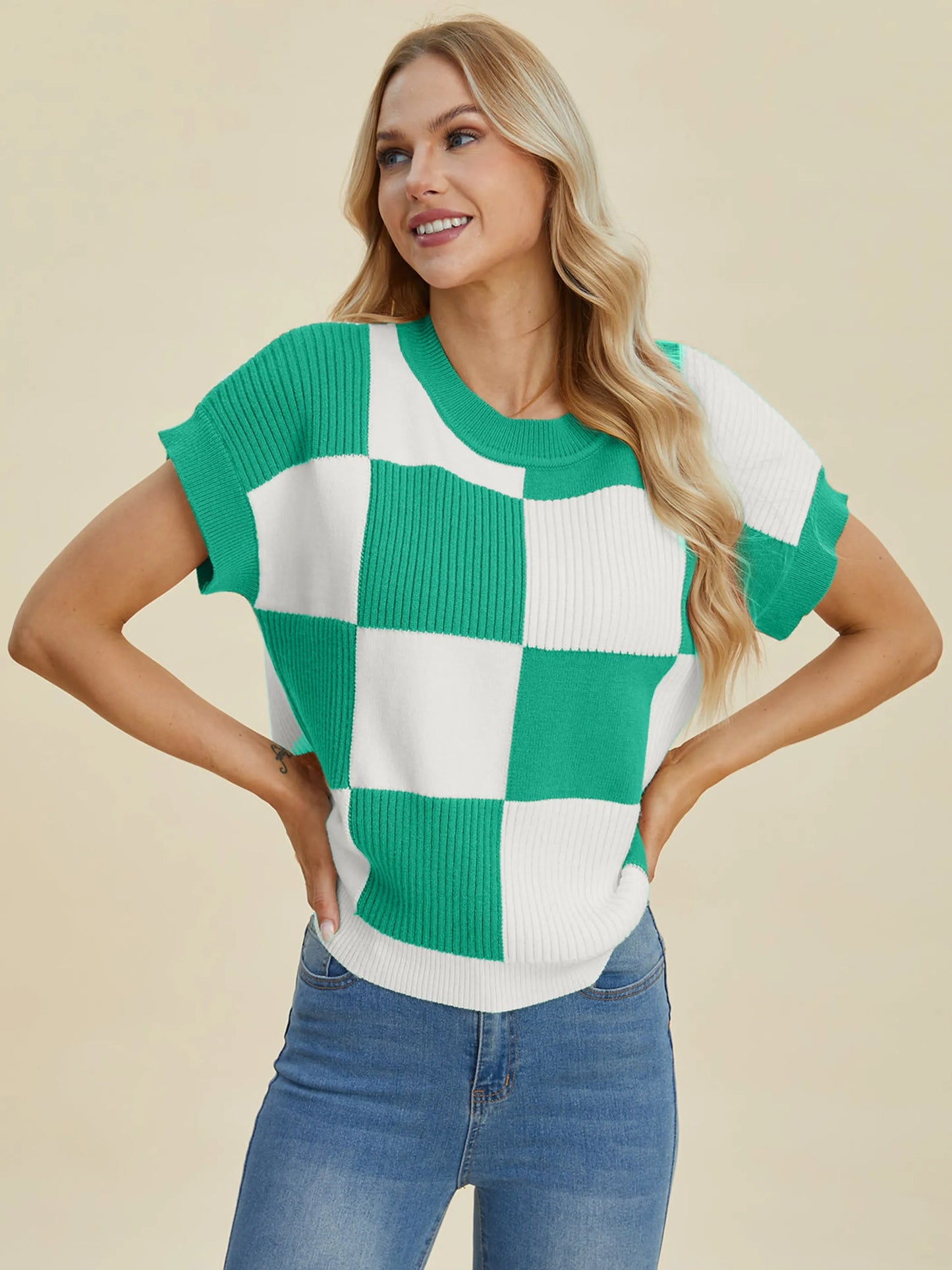Woman wearing a green and white checkered top smiling with hands on hips, Double Take Full Size Checkered Round Neck Short Sleeve Sweater