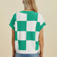 Woman wearing Double Take Full Size Checkered Round Neck Short Sleeve Sweater in green and white checkered pattern viewed from back