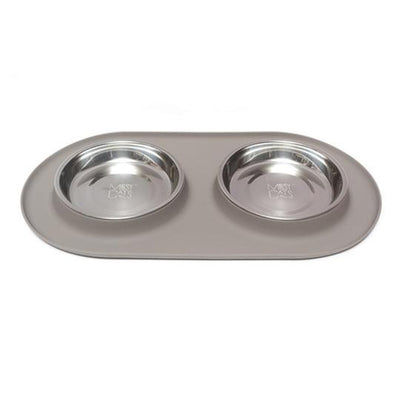 Two stainless bowls set into an oval grey silicone feeding base