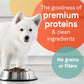 White puppy standing next to a full metal bowl of CANIDAE PURE Farm To Bowl GrainFree LID Dry Puppy Food Wild Caught Salmon Sweet Potato, 1ea/22 lb