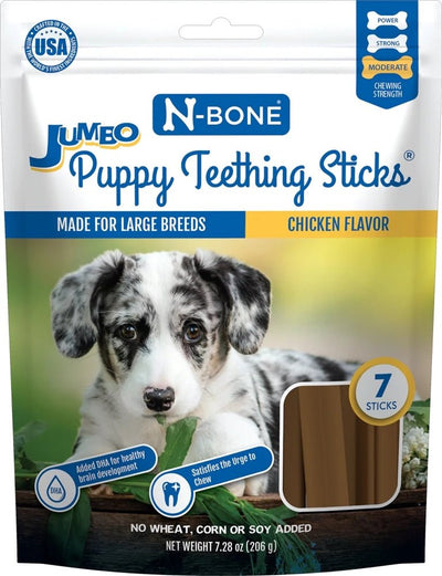 Jumbo chicken flavor teething sticks bag showing spotted puppy chewing on greenery