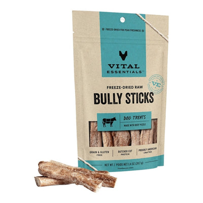 A bag of Vital Essentials Freeze-Dried Raw Bully Sticks for dogs, with two bully sticks lying in front of it.