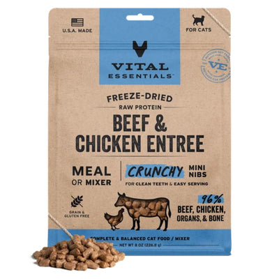 Kraft paper pouch of Vital Essentials freeze-dried beef and chicken cat food with a pile of kibble in front.