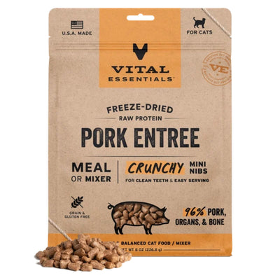 Brown pouch of Vital Essentials Freeze-Dried Pork Mini Nibs cat food with a pile of kibble in front.
